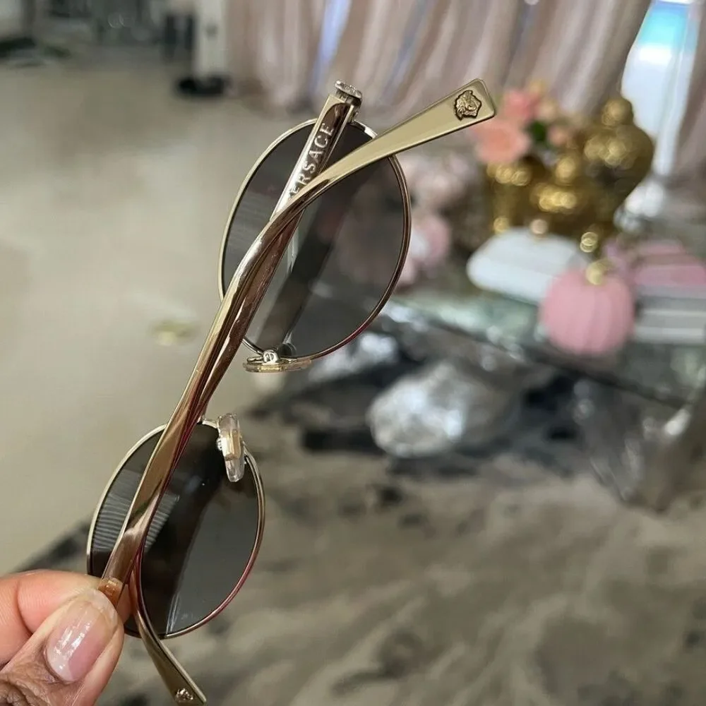 Beautiful  Versace Sunglasses feature mirrored silver lenses and gold rim.